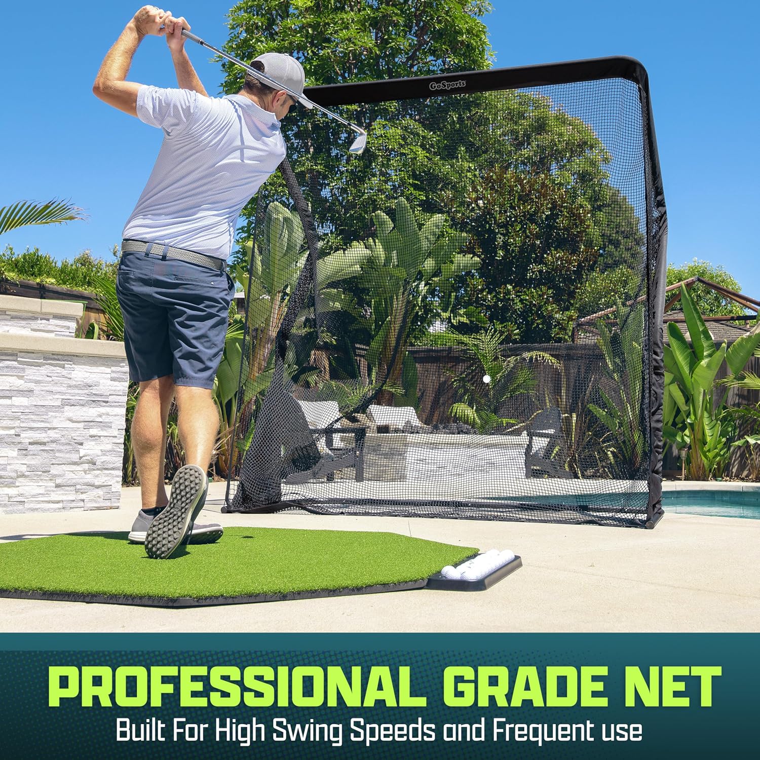 Man practicing golf swings on a professional grade net in an outdoor setting.