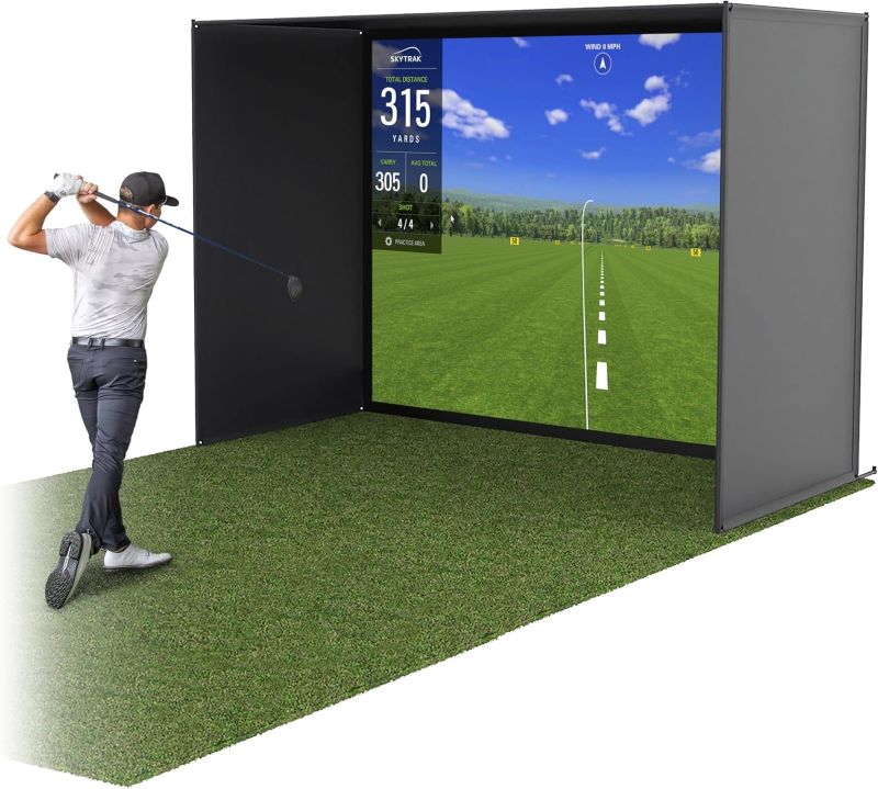 Golf simulator setup with a screen displaying a golf course and a person。