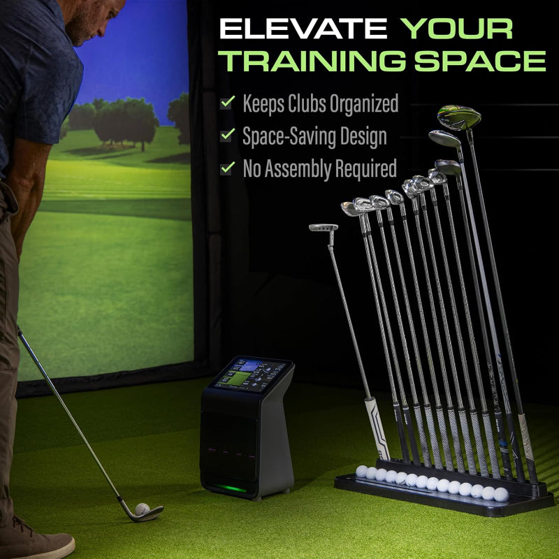 Golf training simulator setup with golf clubs and balls on a green surface.