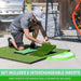 Man setting up a golf practice mat with golf balls outdoors.