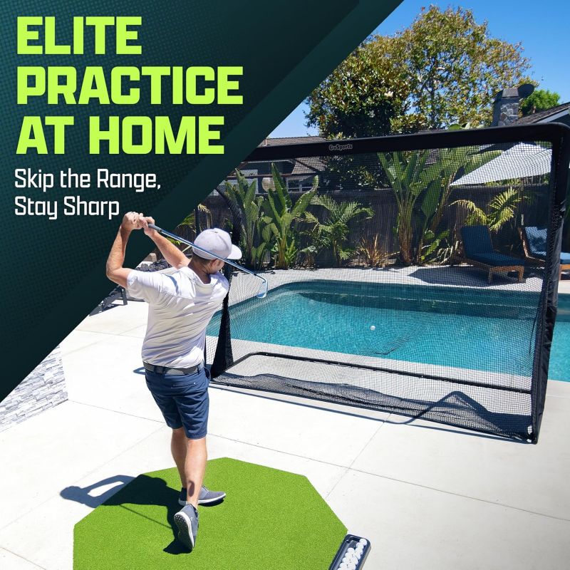 Person practicing golf swings with a netted hitting area near a pool.