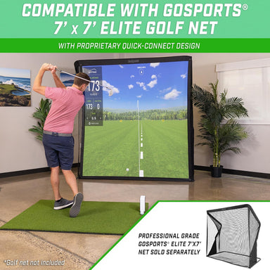 Person using a golf simulator with a screen displaying a golf course, indoors.