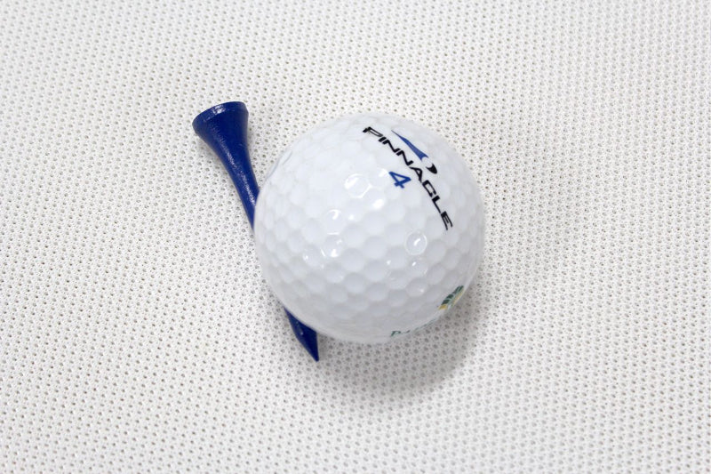 Golf ball with a blue tee on a textured white background