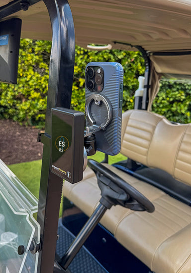 Phone and launch monitor mounted on a golf cart with a green background
