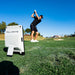 Person practicing golf swing with a Full Swing launch monitor on a golf course.