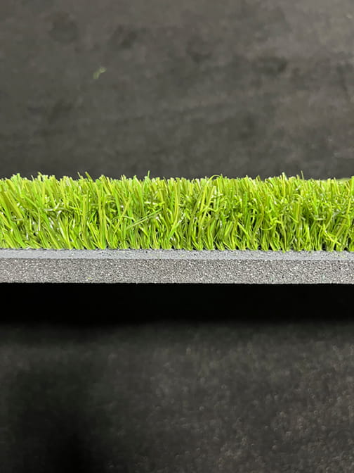 Close-up of artificial turf with a black background
