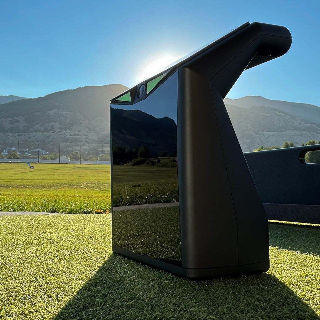 TruGolf LaunchBox shown on a golf range with scenic background