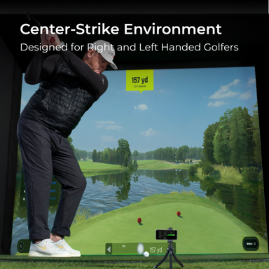 Golfer practicing on a screen displaying a golf course with trees and water.