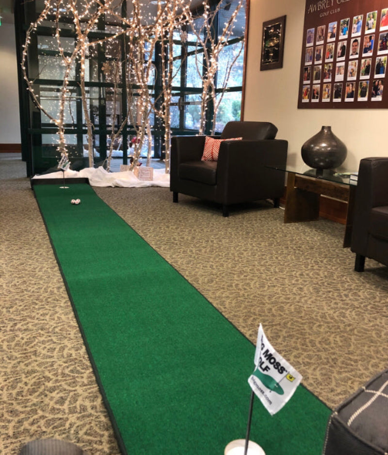 Indoor putting green setup with decorative elements in a room.