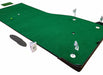 Green putting green mat with golf balls and flags on a wooden floor