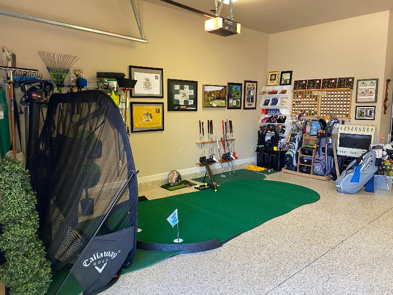 Golf simulator setup in a room with various golf equipment and decor.