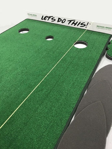 Green putting green mat with holes and 'Let's Do This!' text, featuring a golf club.