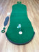 Green putting green mat with accessories on a wooden floor
