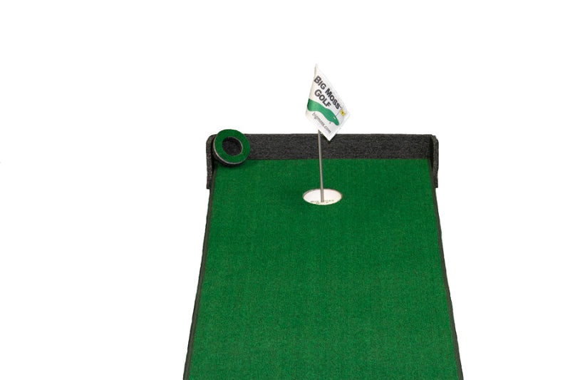 Green putting mat with a flag and hole on a white background